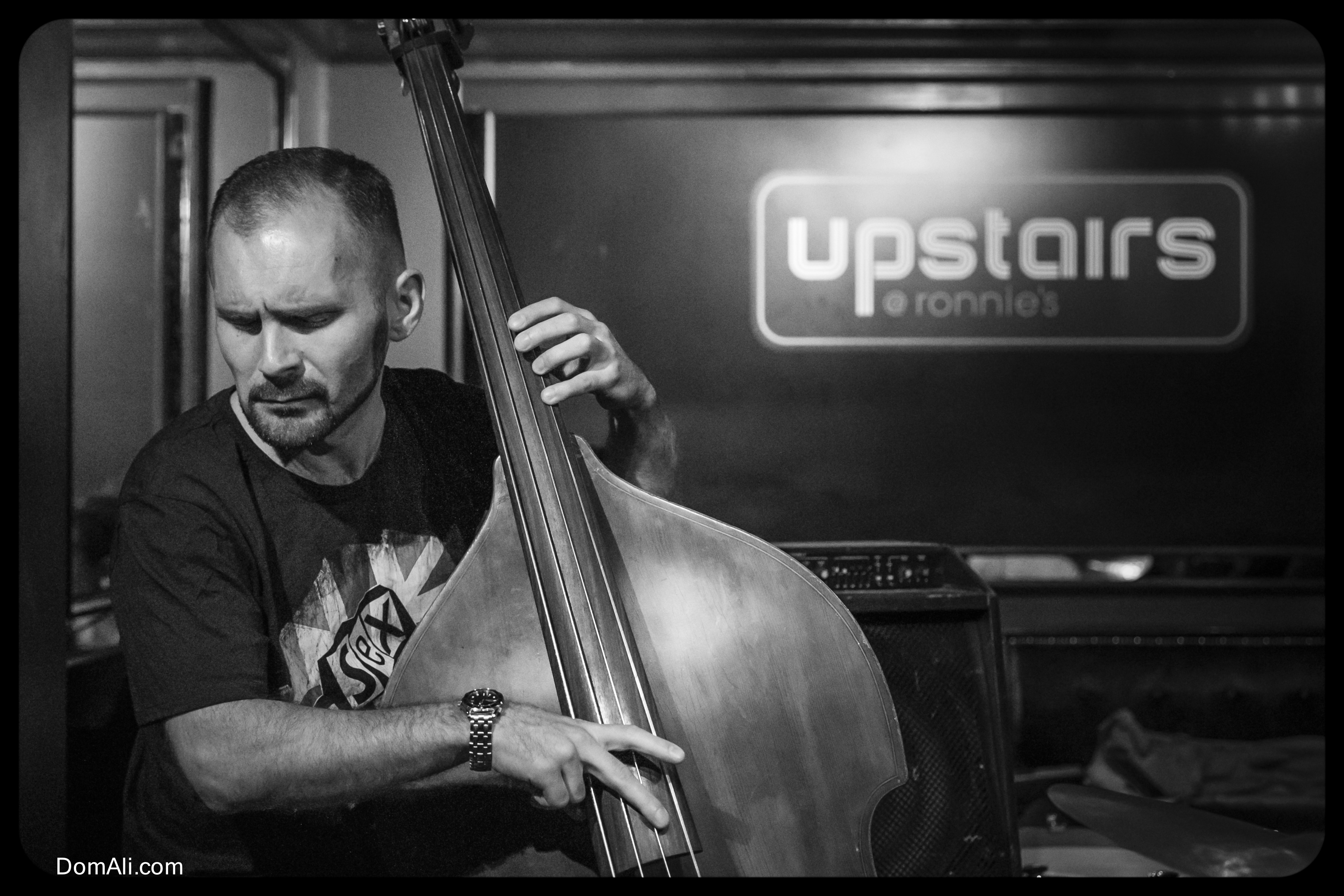 Double bass player at a jazz club called Upstairs at Ronnie's (London, England)